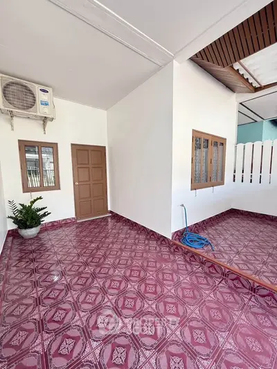 Charming outdoor patio with patterned tiles and air conditioning unit, perfect for relaxation.