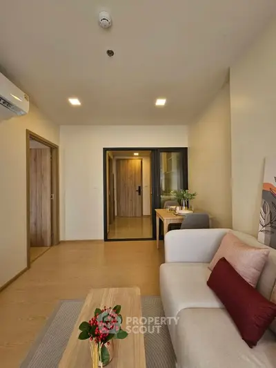 Modern living room with cozy sofa and stylish decor in a contemporary apartment.