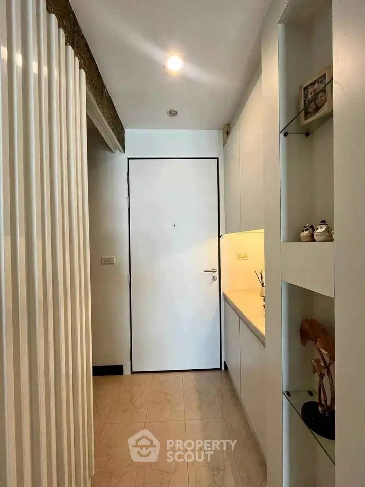 Modern apartment entrance with sleek design and built-in shelving
