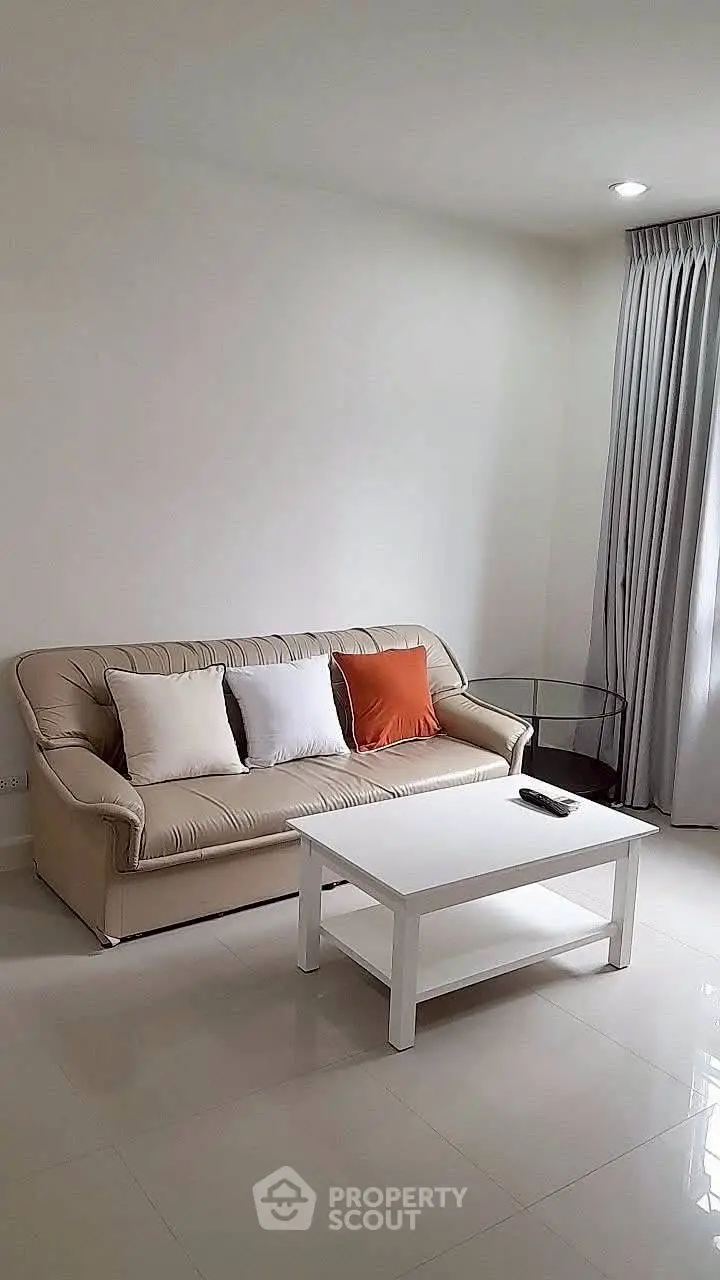 Cozy living room with elegant sofa and modern coffee table, perfect for relaxation.