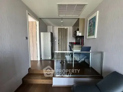 Modern kitchen with sleek design and stainless steel appliances in a stylish apartment.