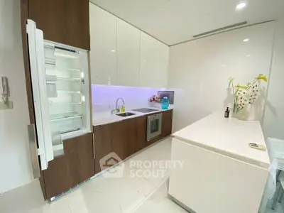 Modern kitchen with open fridge and sleek cabinetry