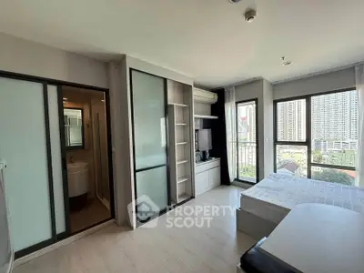 Modern bedroom with city view, featuring sleek design and ample natural light.