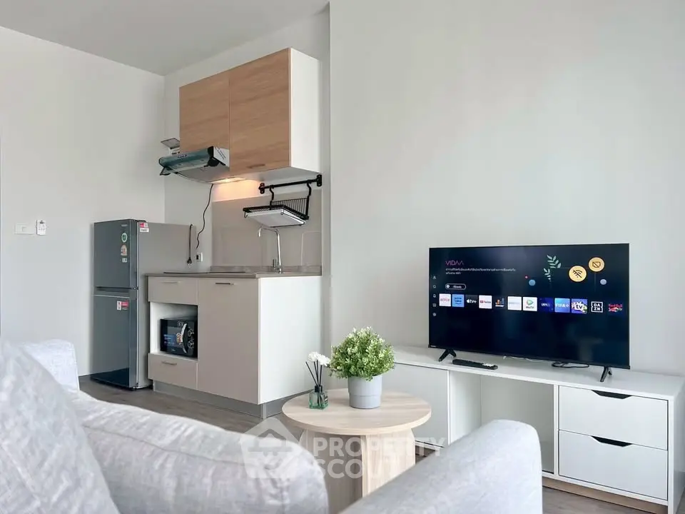 Modern living room with sleek kitchen and smart TV setup
