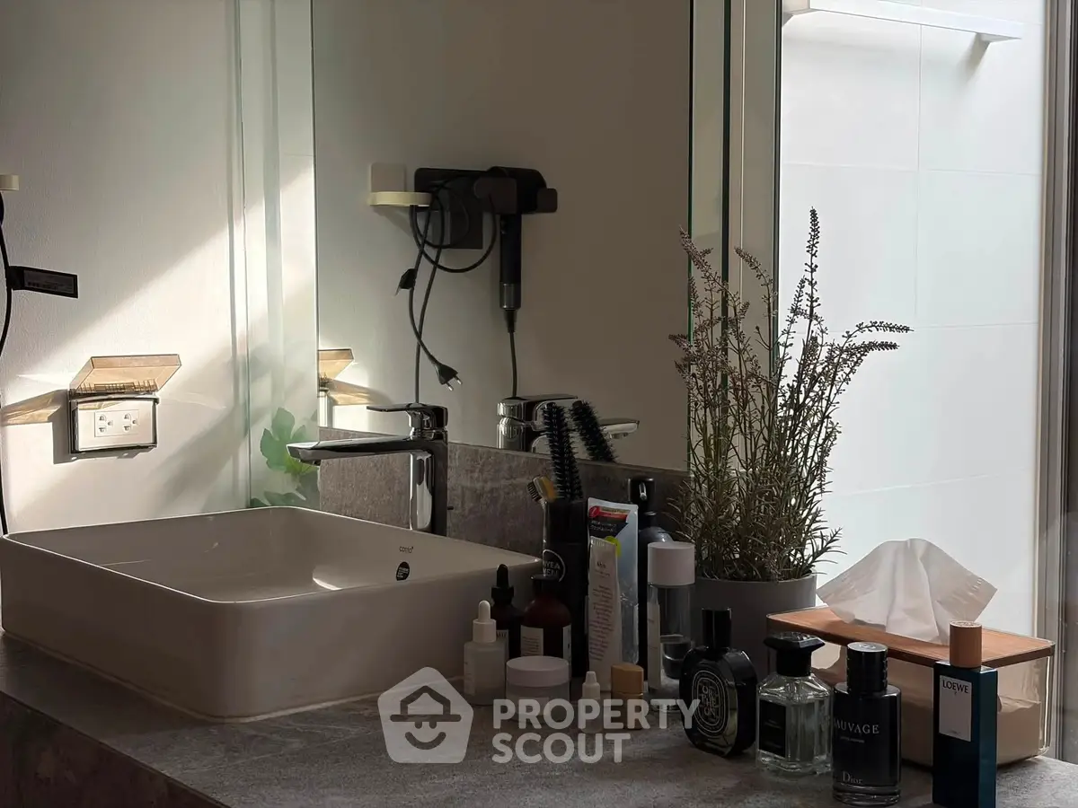 Modern bathroom with stylish sink and elegant toiletries arrangement