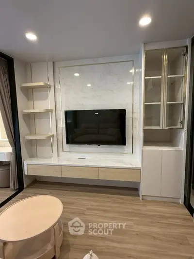 Modern living room with built-in TV unit and elegant shelving