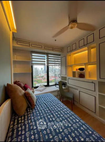 Cozy bedroom with city view, built-in shelves, and stylish decor.
