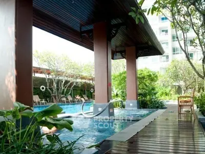 Luxurious outdoor pool area with lush greenery and modern design, perfect for relaxation and leisure.
