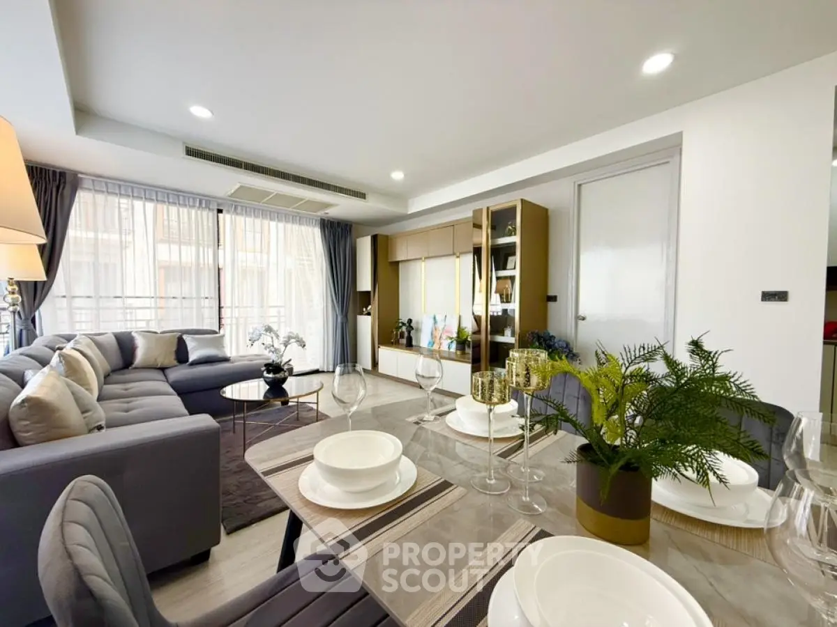 Luxurious modern living room with elegant dining area and large windows
