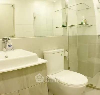 Modern bathroom with glass shower and sleek fixtures in a contemporary apartment.