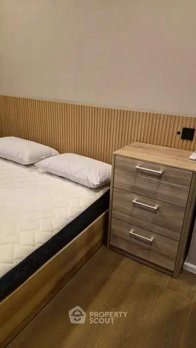 Modern bedroom with stylish wooden headboard and sleek bedside table