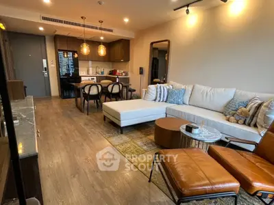 Modern living room with stylish furniture and open kitchen layout in a cozy apartment.