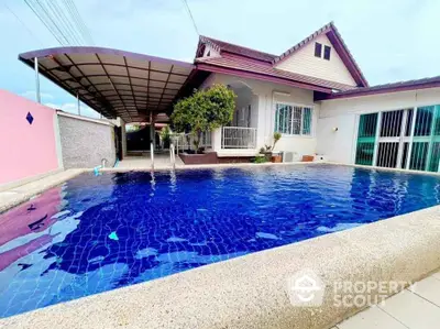 Charming house with a spacious swimming pool and covered parking area, perfect for family living.