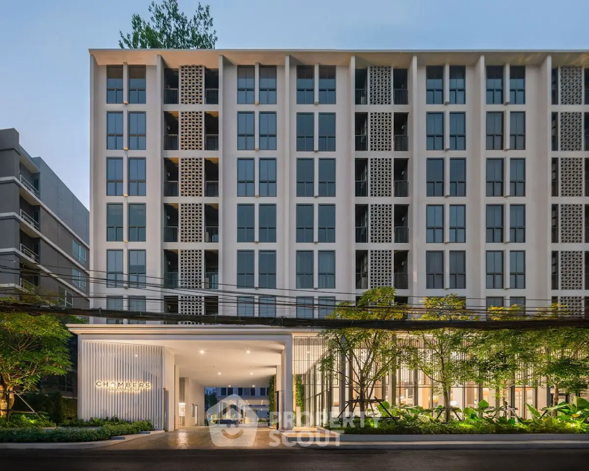Modern apartment building exterior with lush greenery and sleek design