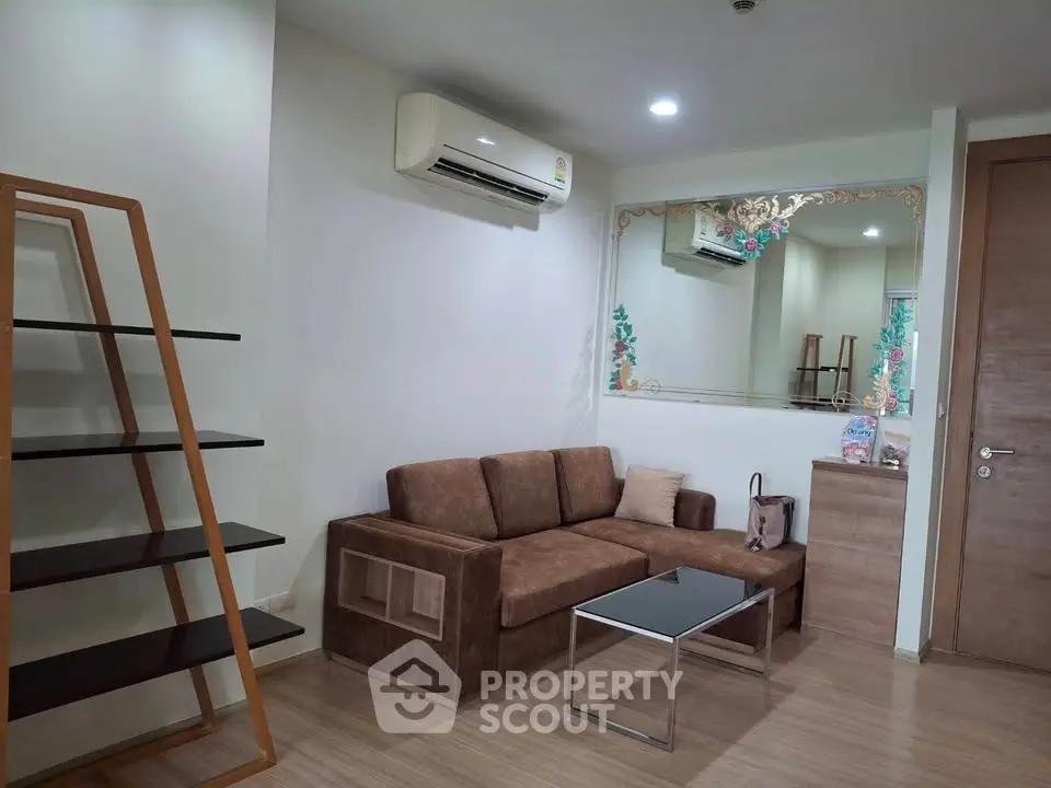 Modern living room with brown sofa, sleek shelving, and air conditioning in a stylish apartment.
