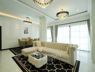 Luxurious living room with elegant chandeliers and plush sofa in a modern home