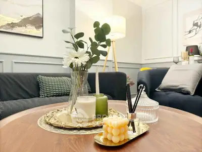 Stylish living room with elegant decor and cozy ambiance, featuring modern furniture and chic lighting.
