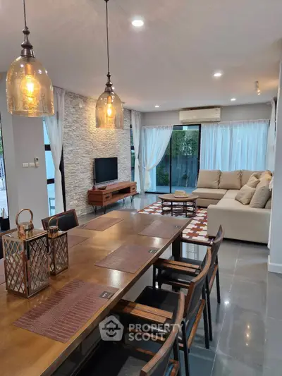 Spacious modern living room with elegant decor and large windows for natural light.