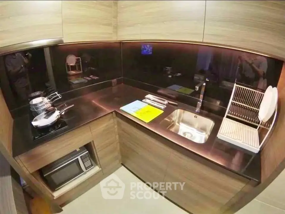 Modern kitchen with sleek wooden cabinets and built-in appliances