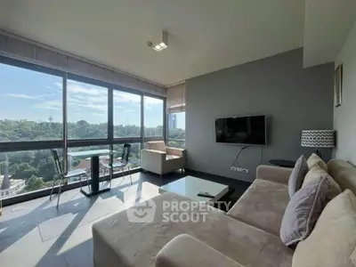 Spacious living room with panoramic windows and stunning city view, featuring modern furniture and natural light.