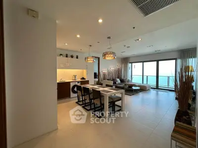 Luxurious open-plan living room with ocean view and modern kitchen