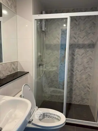 Modern bathroom with glass shower enclosure and sleek fixtures