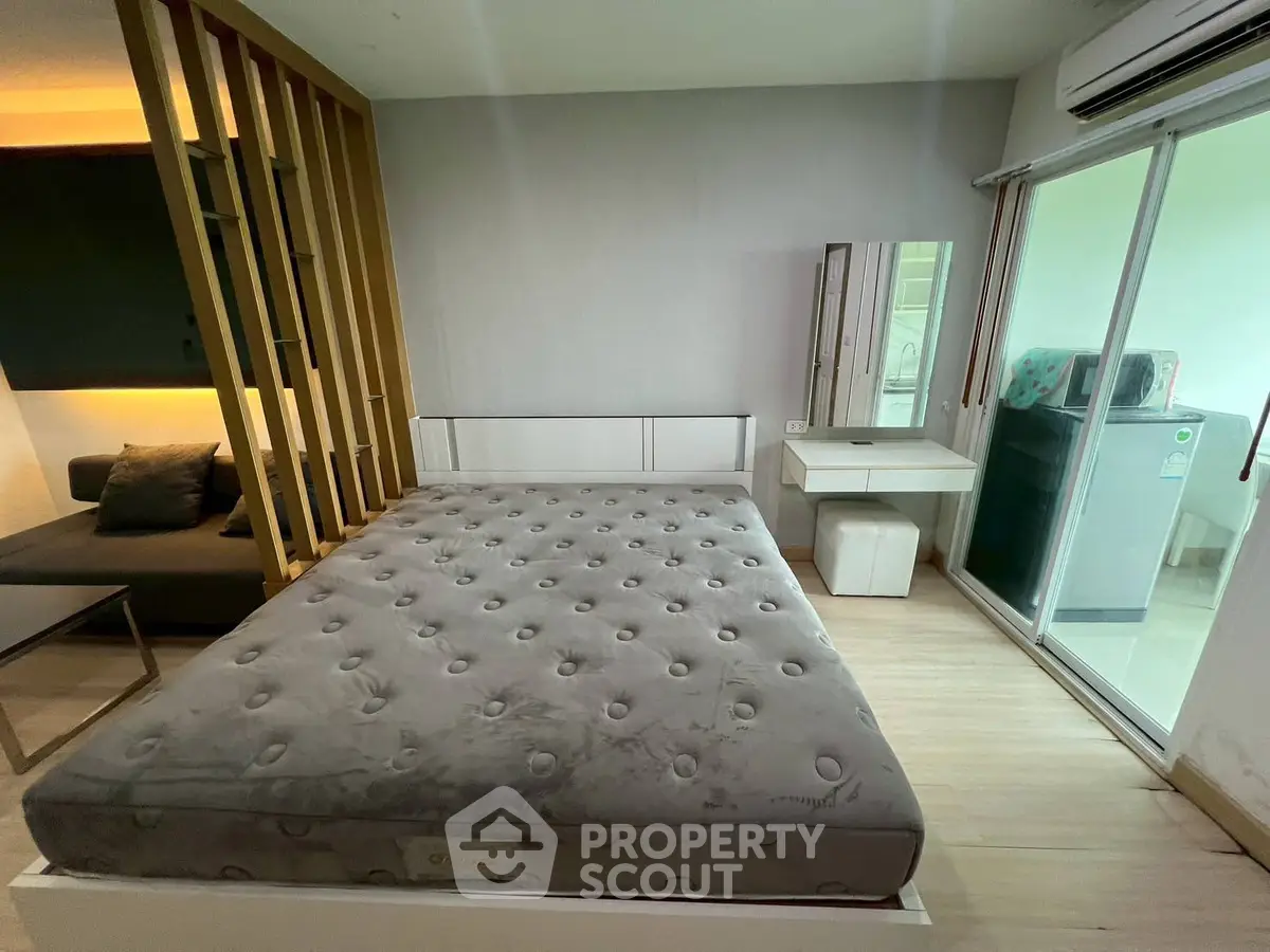 Modern bedroom with stylish partition and access to laundry area