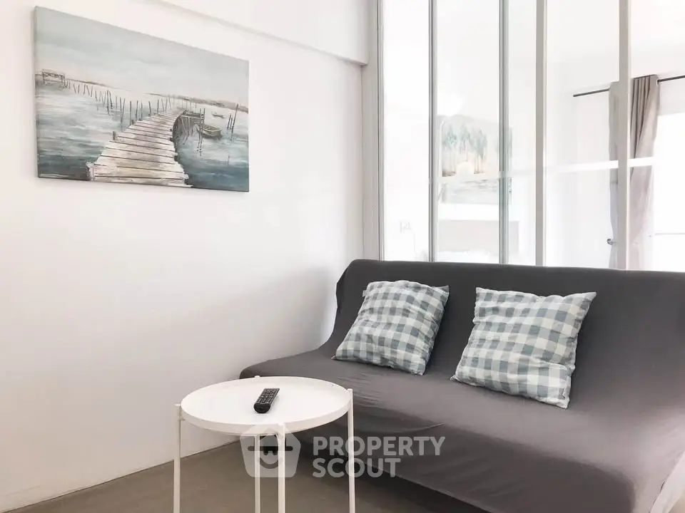 Charming living room with cozy sofa and stylish decor, perfect for relaxation.