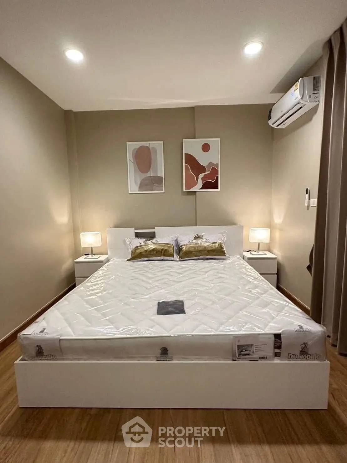 Modern bedroom with stylish decor and air conditioning in a cozy apartment.