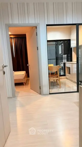 Modern apartment interior with open kitchen and cozy bedroom view