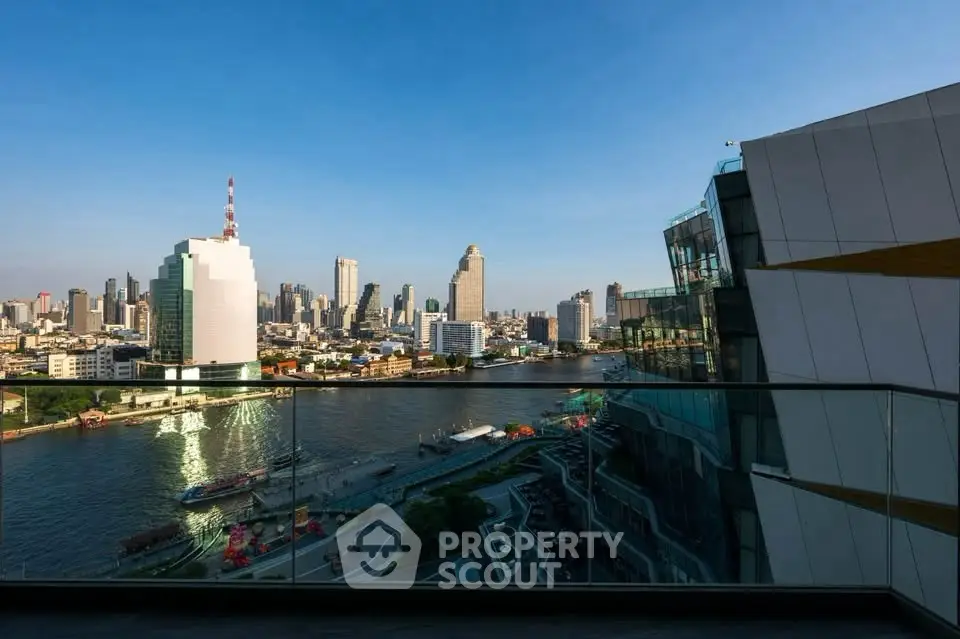 Stunning cityscape view from a modern balcony overlooking a river and skyline.