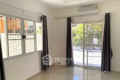 Bright and airy room with large windows and modern air conditioning unit