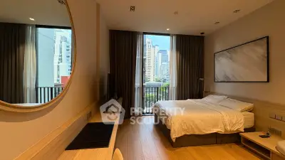 Spacious bedroom with city view and modern decor