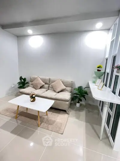 Modern living room with sleek furniture and bright lighting, perfect for cozy gatherings.