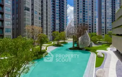 Luxurious modern apartment complex with stunning pool and unique architectural design.