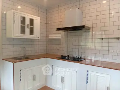 Modern kitchen with gas stove and white subway tiles