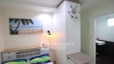 Cozy bedroom with beach-themed decor and modern lighting