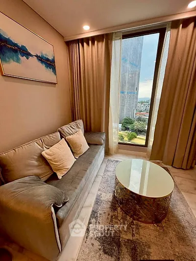 Cozy living room with modern sofa and city view through large window.