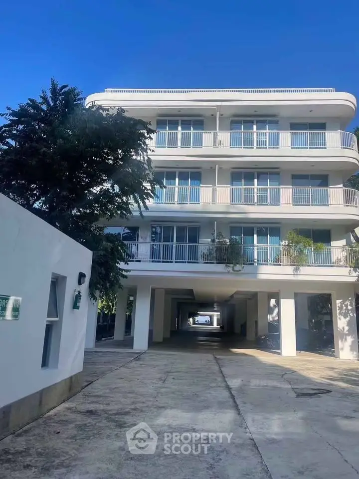 Modern multi-story building with spacious balconies and a sleek exterior design, perfect for urban living.