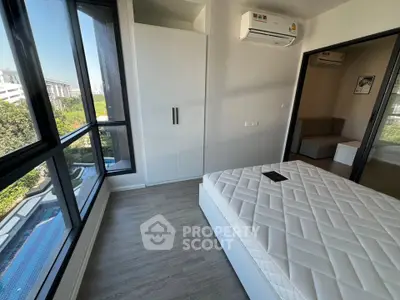 Modern bedroom with large windows and pool view in a stylish apartment