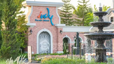 Charming residential entrance with elegant fountain and lush greenery