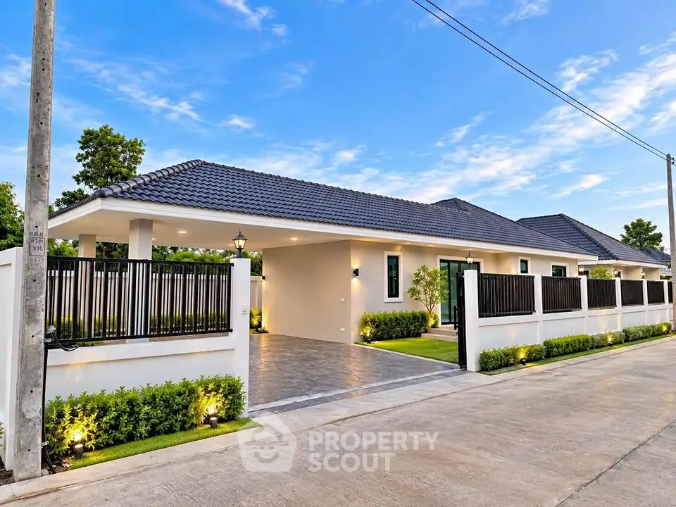Modern single-story home with sleek design and spacious driveway in a serene neighborhood.