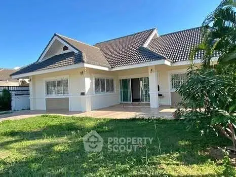 Charming single-story house with lush garden and spacious patio, perfect for family living.