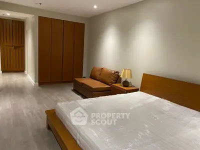 Spacious modern bedroom with wooden furniture and cozy lighting