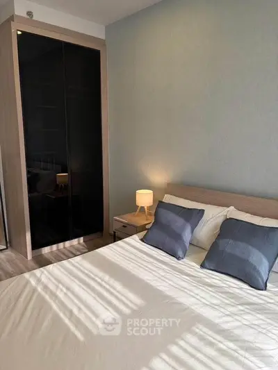 Modern bedroom with stylish decor and ample natural light