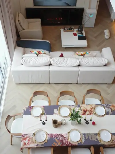 Stylish living room with elegant dining setup and cozy seating area.