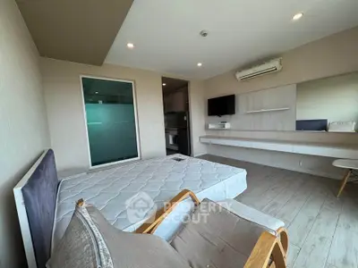 Modern bedroom with minimalist design, featuring a large window, air conditioning, and sleek furniture.
