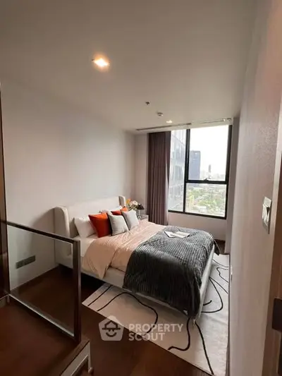 Modern bedroom with large window and city view, featuring stylish decor and cozy ambiance.
