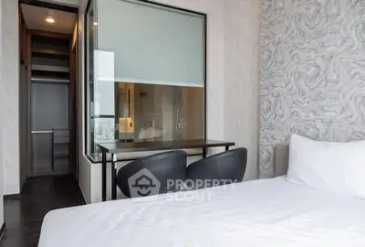 Modern bedroom with stylish decor and large window for natural light