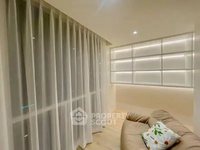 Cozy living room with modern lighting and floor-to-ceiling curtains
